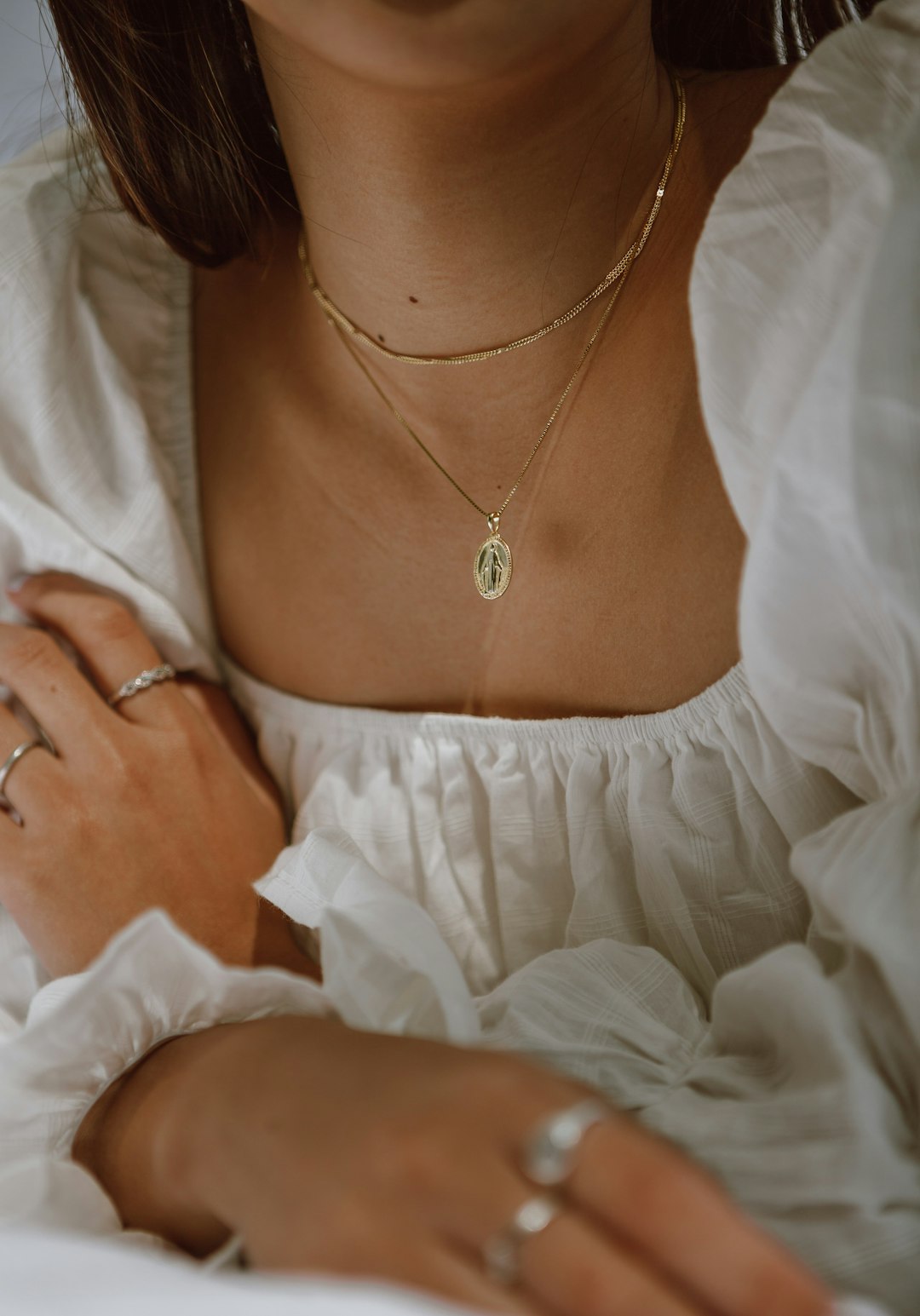 woman-in-white-off-shoulder-dress-wearing-silver-necklace-wkd2vie8rb0